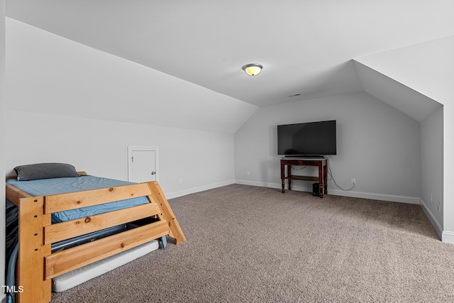 bedroom featuring carpet floors, baseboards, and vaulted ceiling