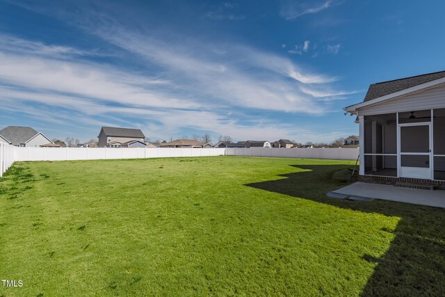 view of yard with a sunroom and a fenced backyard