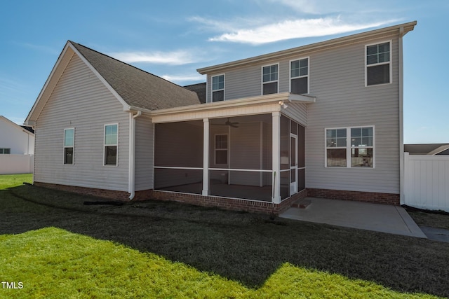 back of house with a sunroom, a lawn, and fence