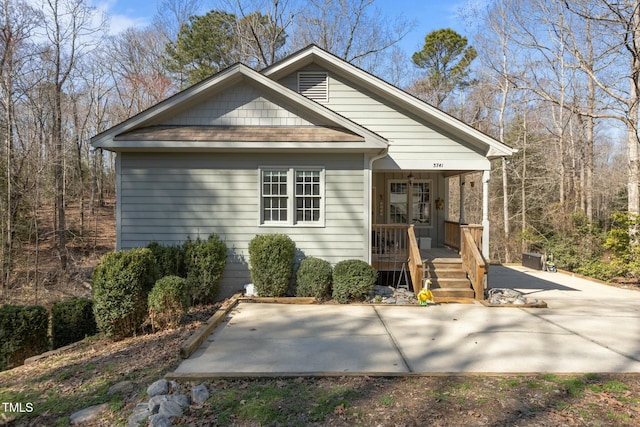 view of front of home featuring covered porch and a shingled roof