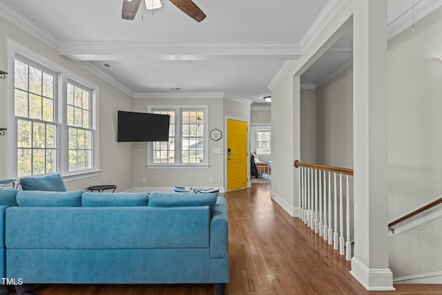 living area with a ceiling fan, wood finished floors, baseboards, and ornamental molding