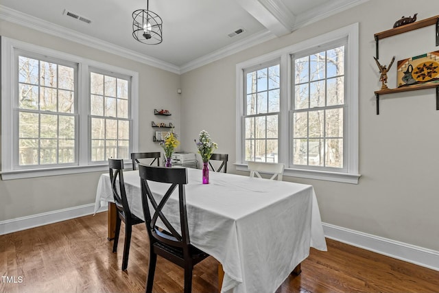 dining room featuring visible vents, baseboards, dark wood-style flooring, and crown molding