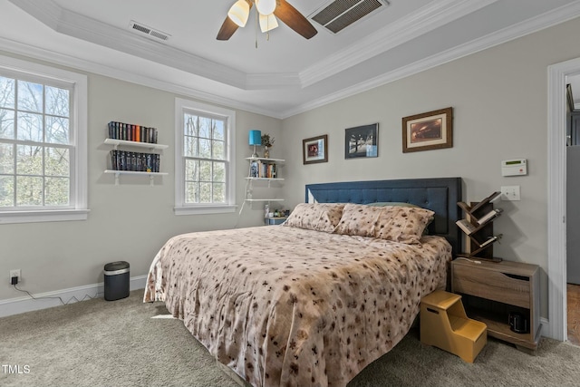 bedroom with visible vents, multiple windows, a raised ceiling, and carpet flooring