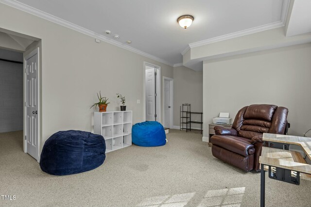 sitting room featuring crown molding, carpet flooring, and baseboards