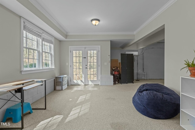 interior space with carpet flooring, french doors, and crown molding