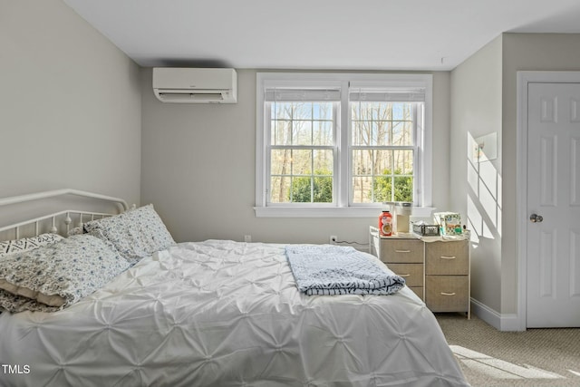 bedroom featuring carpet flooring, a wall mounted air conditioner, and baseboards