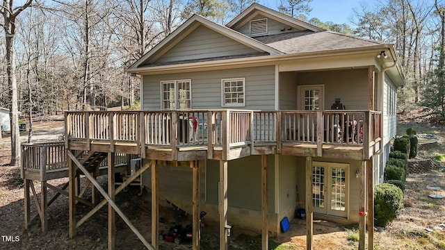 rear view of house featuring french doors, roof with shingles, and a wooden deck