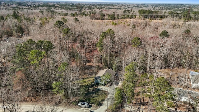 drone / aerial view with a wooded view