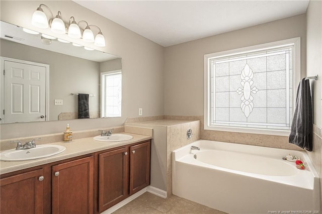 full bath with a garden tub, a sink, visible vents, and tile patterned floors