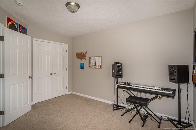 miscellaneous room featuring carpet, baseboards, and a textured ceiling