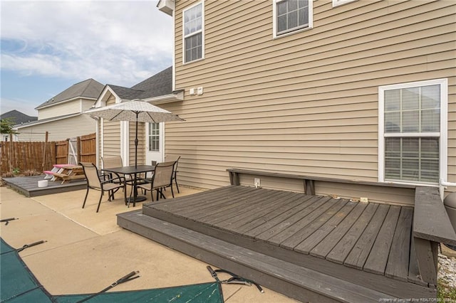 deck featuring a patio area, fence, and outdoor dining space