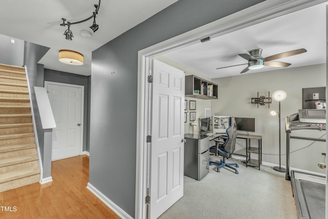 office area with rail lighting, ceiling fan, baseboards, and wood finished floors