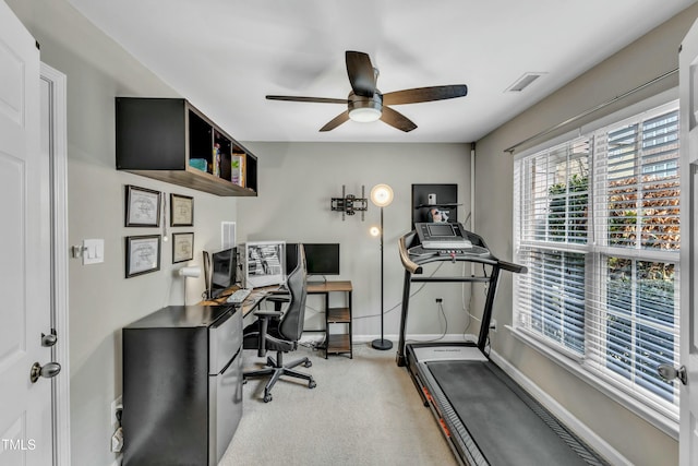 home office featuring carpet, baseboards, visible vents, and a ceiling fan