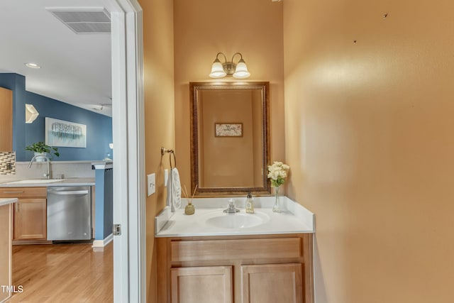 bathroom featuring wood finished floors, vanity, and visible vents