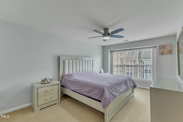 bedroom with baseboards, a ceiling fan, and light colored carpet