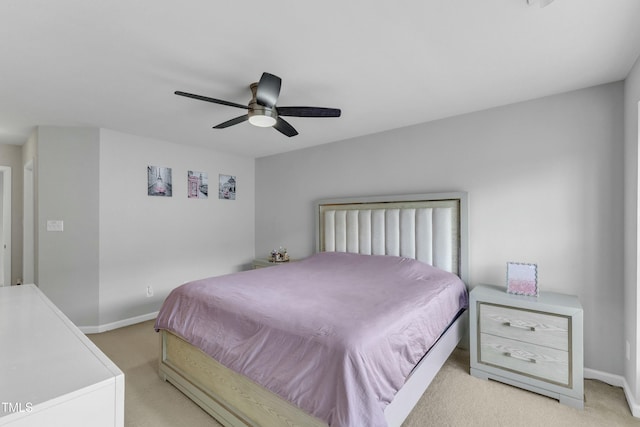 bedroom featuring light carpet, ceiling fan, and baseboards