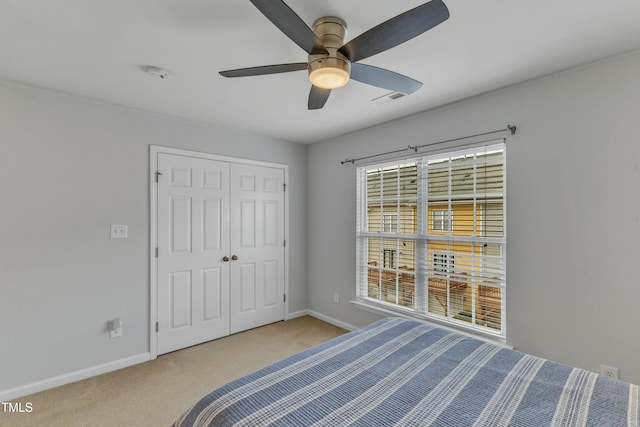 unfurnished bedroom with visible vents, baseboards, a ceiling fan, carpet, and a closet