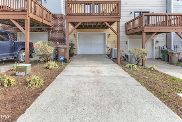 exterior space featuring a garage, central AC, and driveway