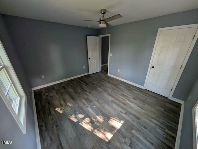 unfurnished bedroom with ceiling fan, baseboards, and wood finished floors