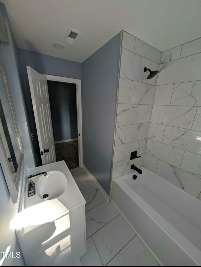 full bath featuring baseboards, visible vents,  shower combination, marble finish floor, and vanity