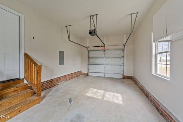 garage featuring a garage door opener, electric panel, and baseboards