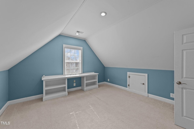 additional living space featuring vaulted ceiling, carpet flooring, visible vents, and baseboards