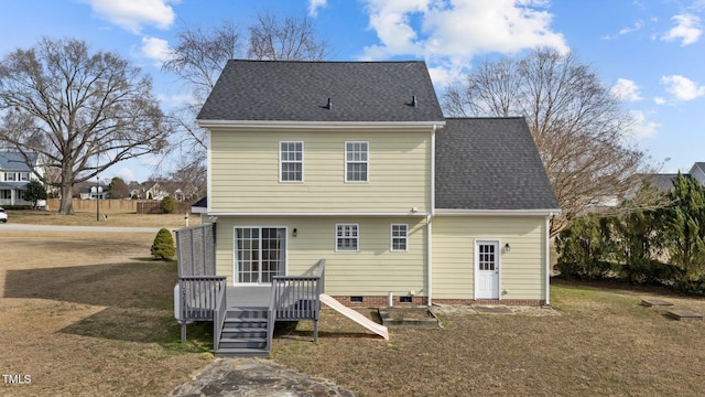 rear view of property featuring a yard, crawl space, roof with shingles, and a wooden deck