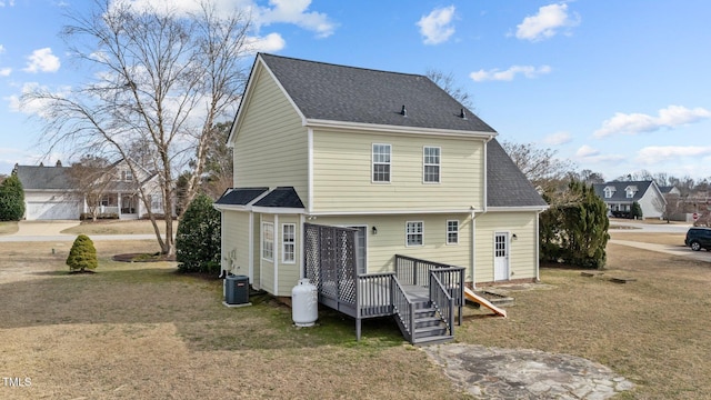 rear view of property featuring central air condition unit, a shingled roof, and a deck