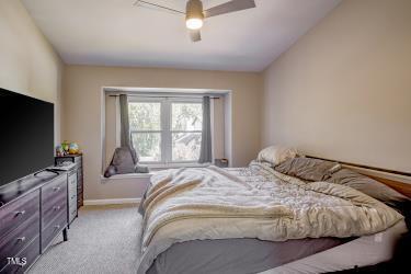 bedroom with carpet floors, ceiling fan, and baseboards