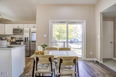 dining area featuring wood finished floors and baseboards