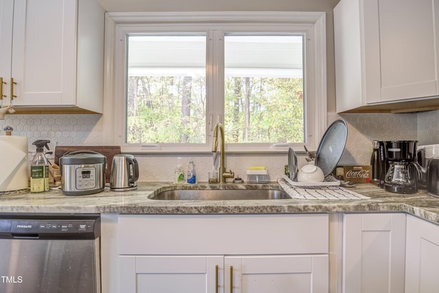 kitchen with a sink, decorative backsplash, white cabinets, and dishwasher