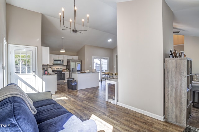 living room featuring dark wood-style floors, high vaulted ceiling, recessed lighting, a chandelier, and baseboards