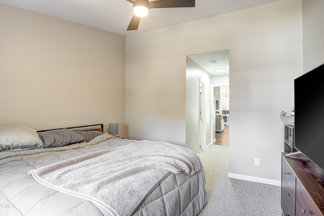 bedroom with a ceiling fan, baseboards, and carpet flooring