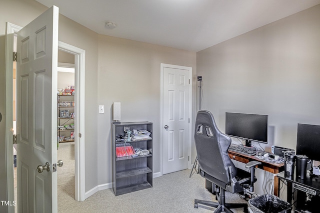 carpeted office space featuring baseboards