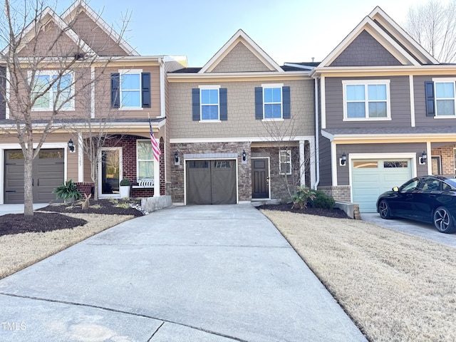 view of front facade with driveway, stone siding, and a garage