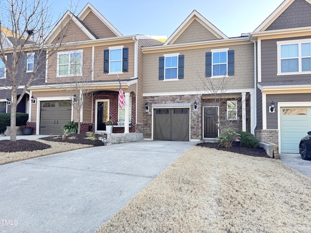 view of front of home with stone siding, driveway, and an attached garage