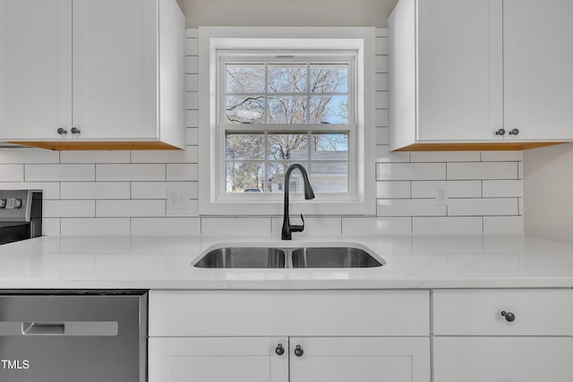 kitchen featuring a healthy amount of sunlight, dishwasher, white cabinetry, and a sink