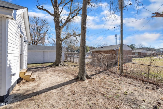 view of yard featuring entry steps and a fenced backyard