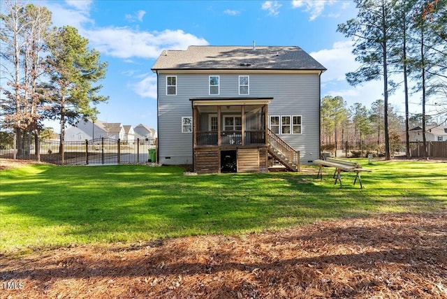 back of house featuring fence, a sunroom, a yard, stairway, and crawl space