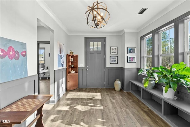 mudroom featuring wainscoting, wood finished floors, visible vents, and a healthy amount of sunlight