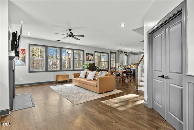 living room featuring recessed lighting, a ceiling fan, baseboards, stairway, and hardwood / wood-style floors