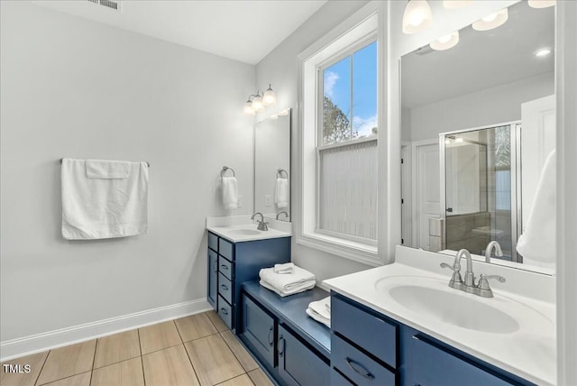 full bathroom featuring a shower stall, vanity, and baseboards