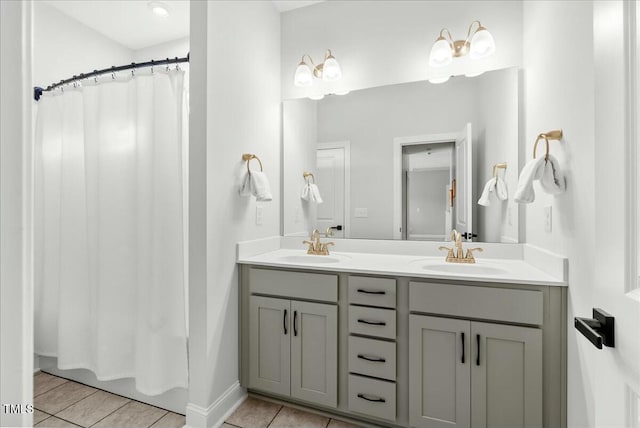 bathroom with double vanity, tile patterned flooring, and a sink