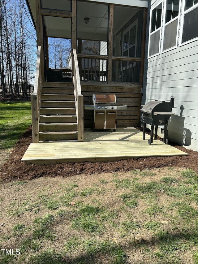 exterior space with stairway, a lawn, and grilling area