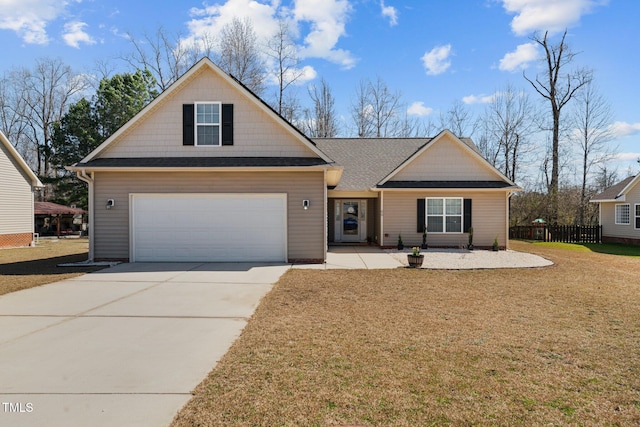 view of front facade featuring driveway, roof with shingles, a front yard, and fence