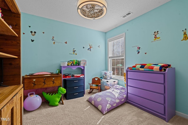 carpeted bedroom featuring baseboards, visible vents, and a textured ceiling