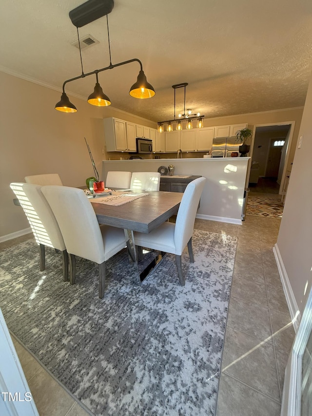 dining area featuring visible vents, baseboards, and light tile patterned floors