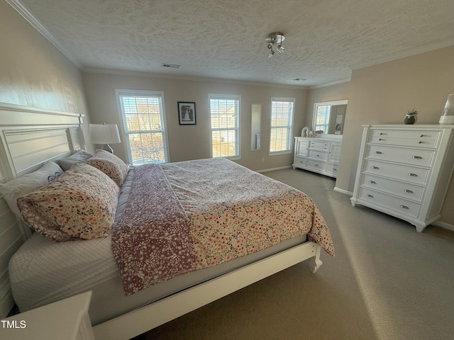 carpeted bedroom with visible vents, crown molding, a textured ceiling, and baseboards