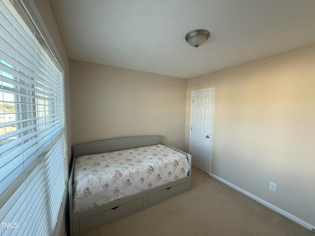 unfurnished bedroom featuring carpet floors and baseboards