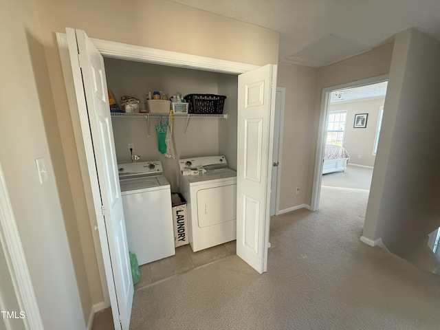 laundry room with light carpet, laundry area, baseboards, and washer and clothes dryer